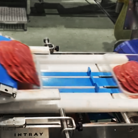 Meat loading on to conveyor belt